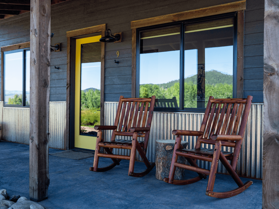 two rock chairs on the porch of a cabin rental on Rock Creek in Montana