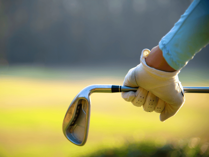 golfer holding a club on a course