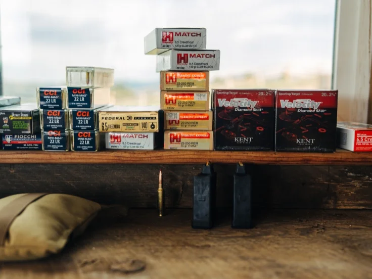 a stack of rifle ammunition on a shelf