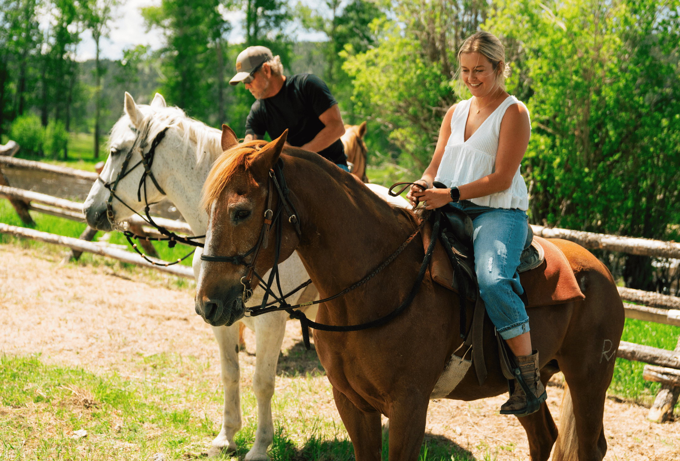 woman sits on a brown horse