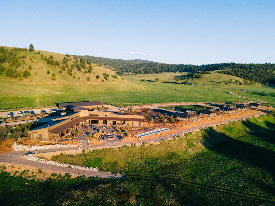 one large structure and five cabins on a hillside