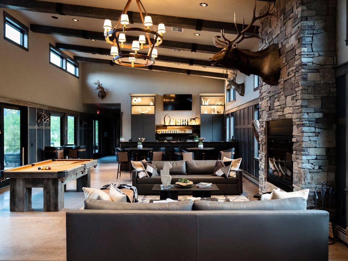 The interior of a large building with a pool table and a bar area