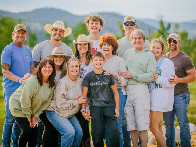 a group of people standing in front of a large valley in montana