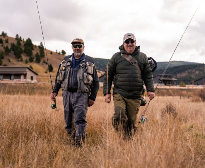 two men walking in the grass