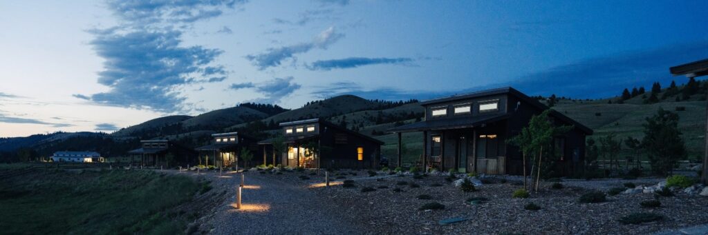 cabins lit up under a night sky