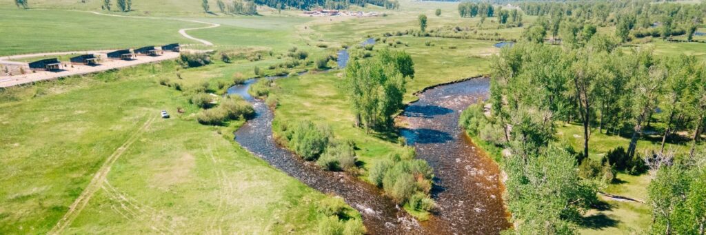 several cabins in front of a river