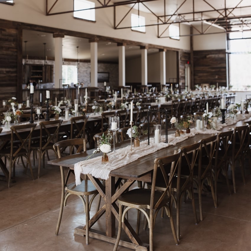 the inside of a wedding reception with decorated tables