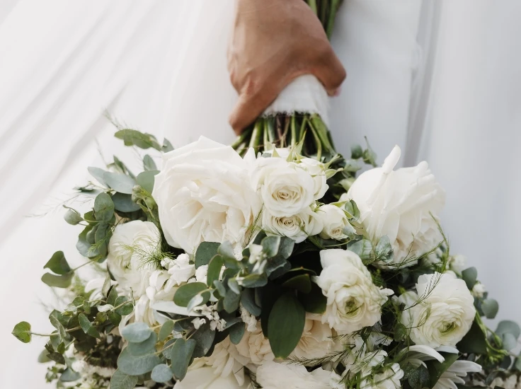 a bride holds a bouquet of flowers