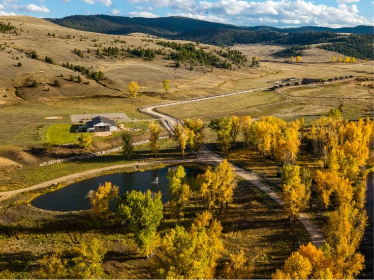 an aerial view of a guest ranch in a picturesque river valley in Montana