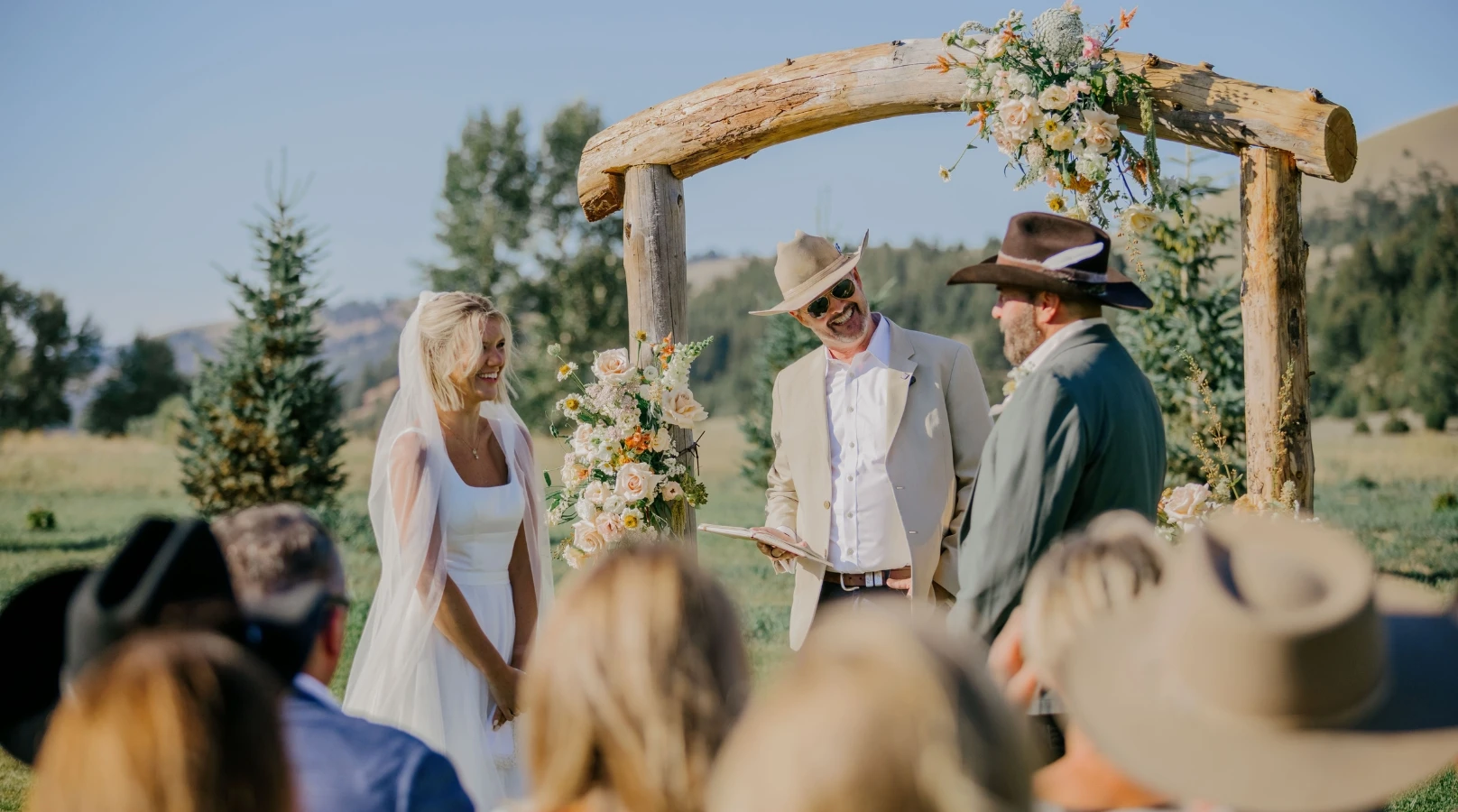 a bride and groom getting married in front of an arch