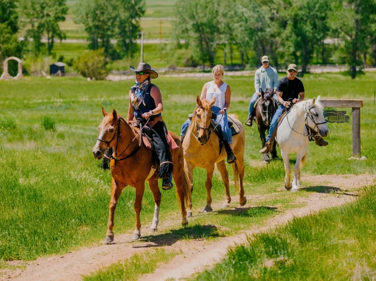 a group of people riding horses