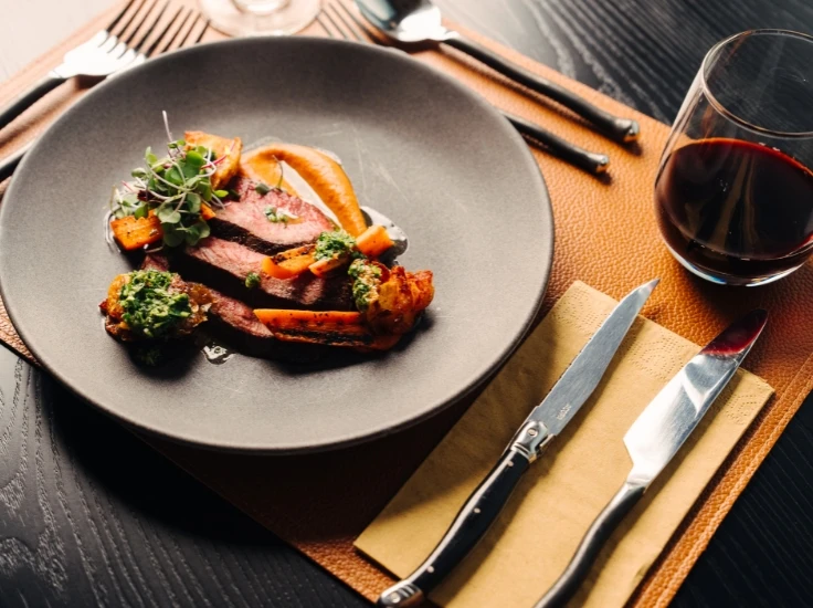 a plate of food on a black table