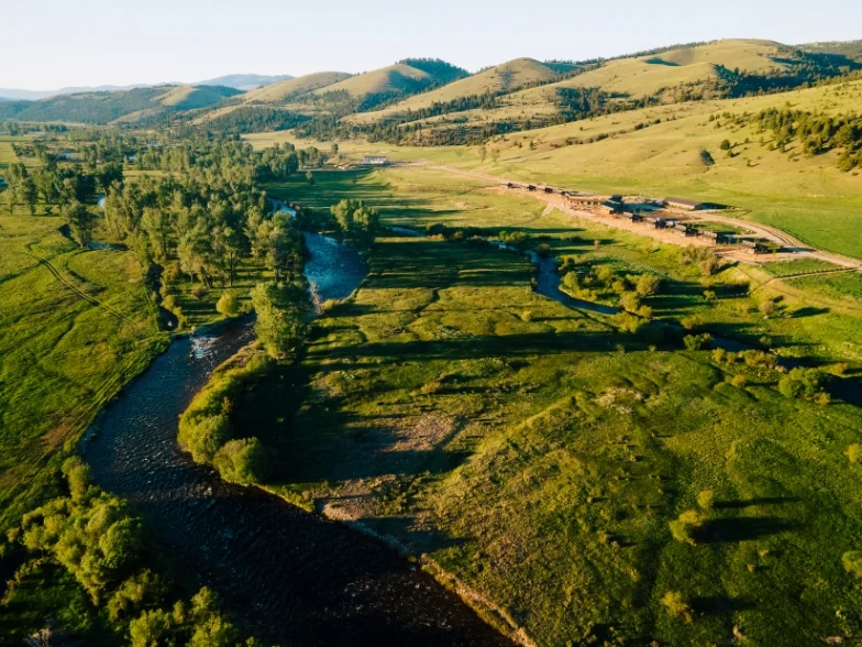 a large guest ranch in a river valley in western montana