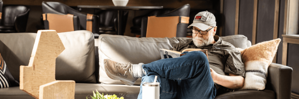 man reading on a couch while on a montana skillcation