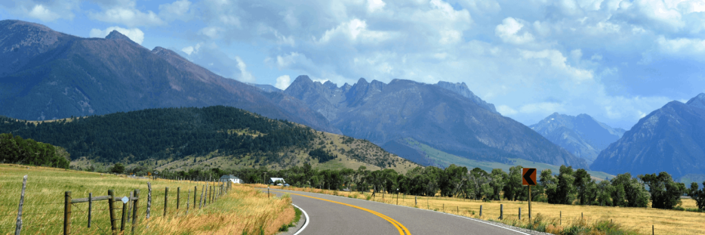 a montana highway with scenic mountains in the background