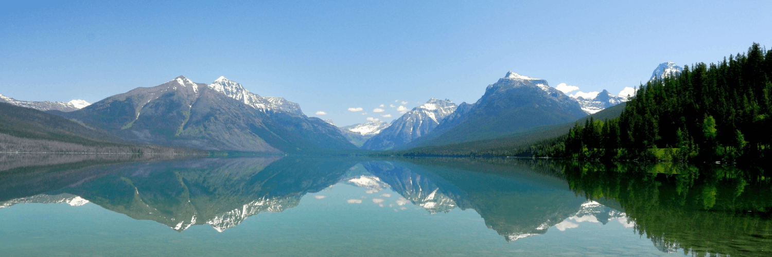 tall mountains mirrored in the lake at Lake McDonald in Glacier National Park
