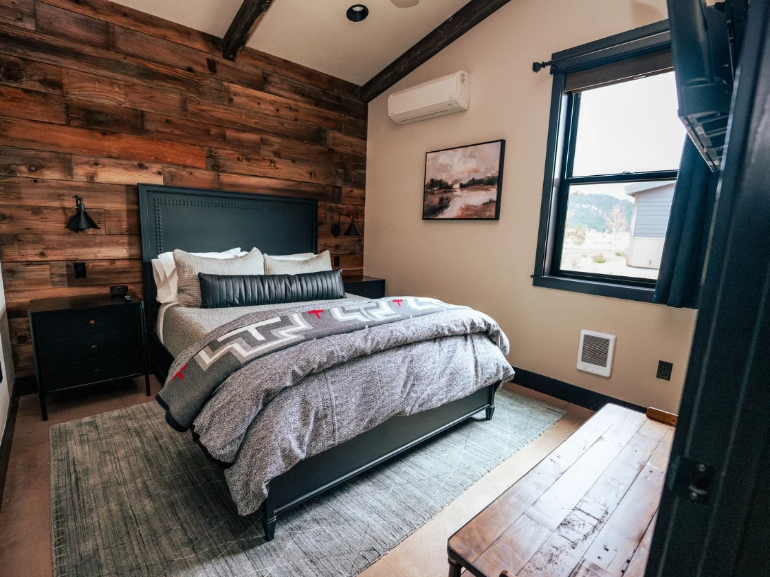 a bedroom with light shining in from a window