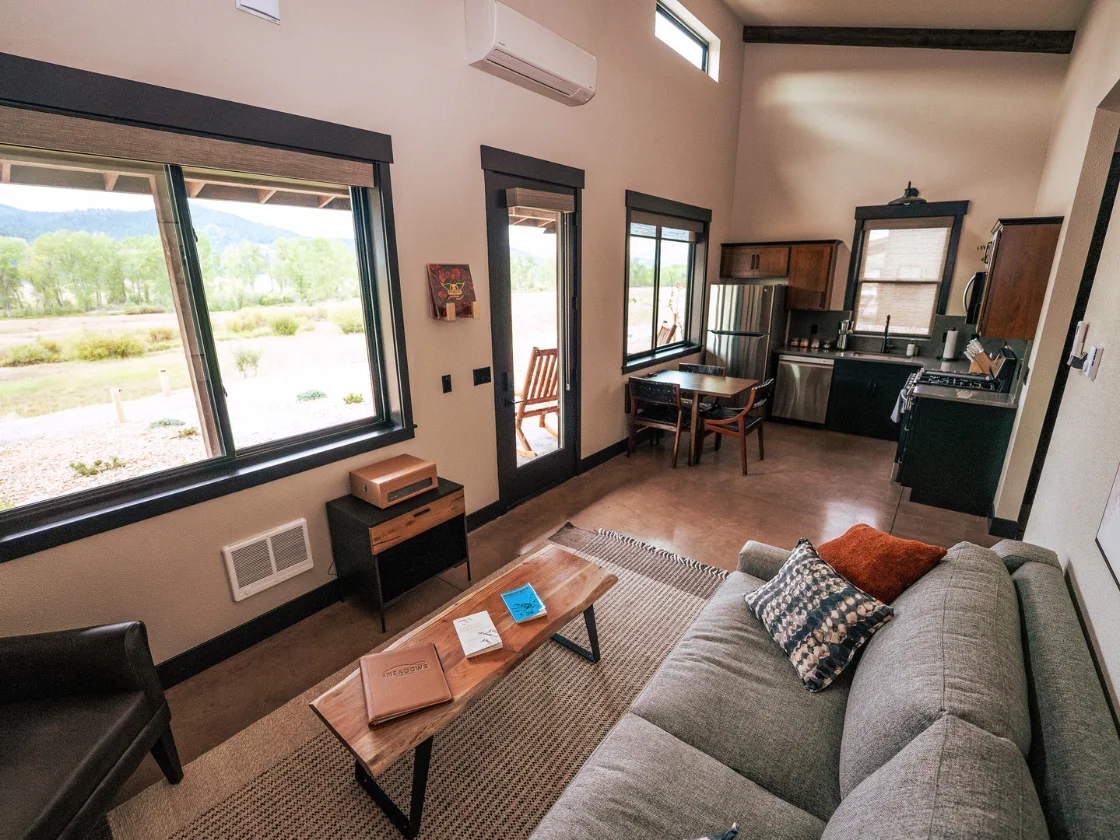 a living room with a couch and full kitchen