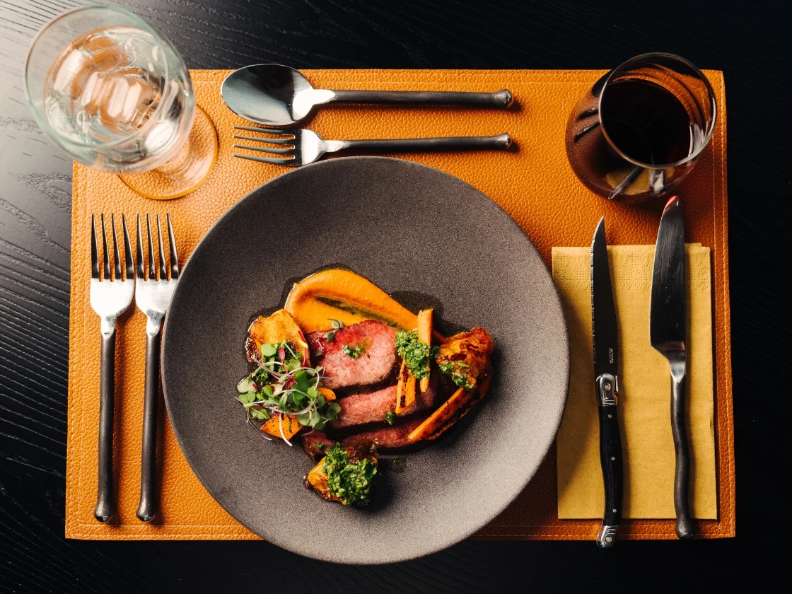 a plate full of food on an orange placemat